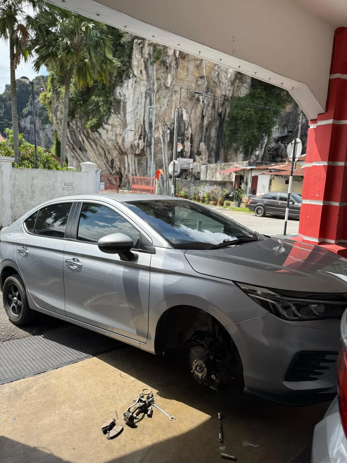 Car undergoing mechanical repair work at Otoka Garage